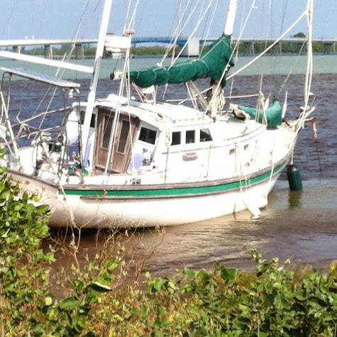 Sailboat aground needing marine survey and damage inspection