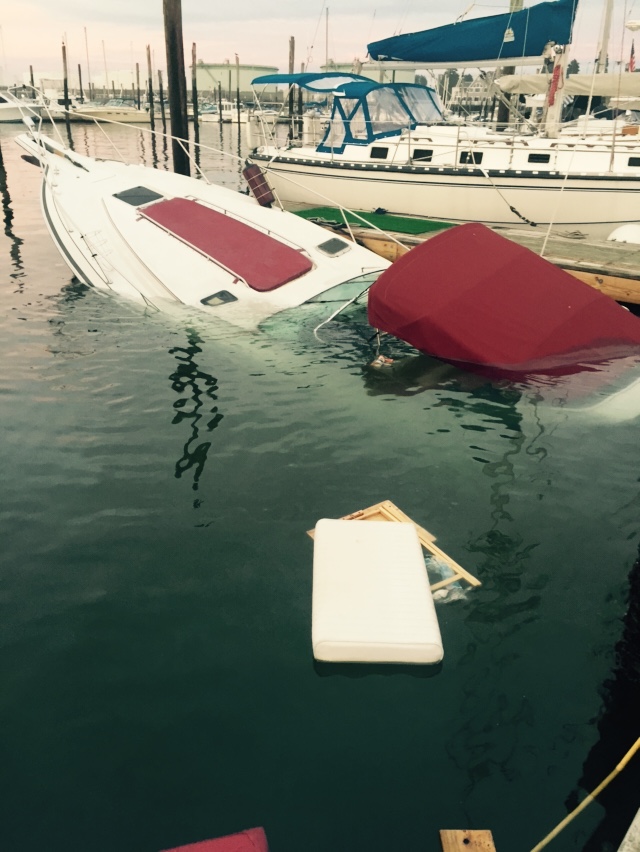 Sinking boat at the marina. Marine survey damage inspection required